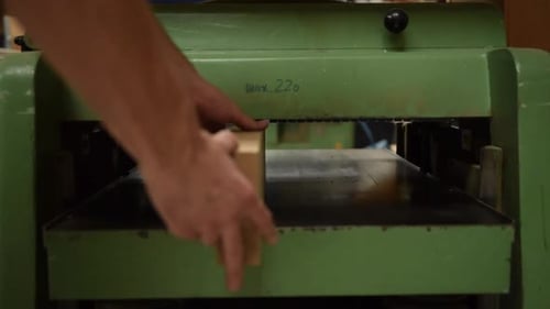 Wood Block Inserted Into Woodworking Machine
