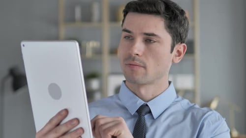 Young Adult Using Tablet at Office