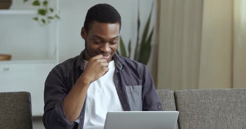 Young Man Video Conferencing on Tablet in Living Room
