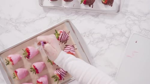 Flat lay. Step by step. Garnishing chocolate dipped strawberries with drizzled chocolate.