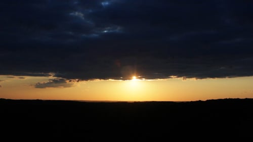 Fiery Golden Sunset with Dramatic Clouds