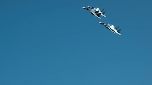 Three Jets Fly in Formation in Blue Sky