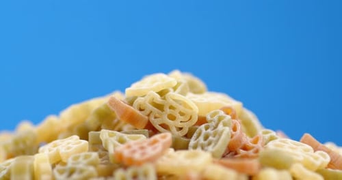 Colorful Shaped Pasta Close Up on Blue Background