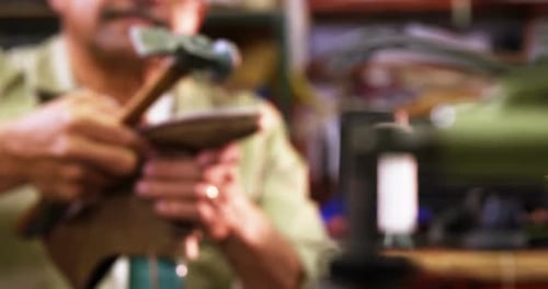 Cobbler Repairing a Shoe in his Workshop