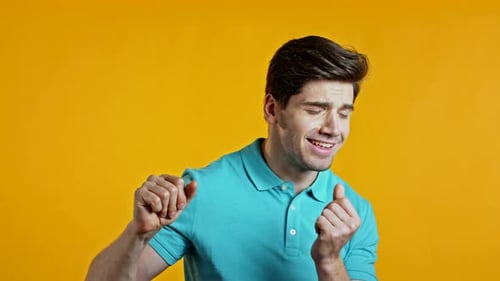 Man Dancing Happily on Yellow Background