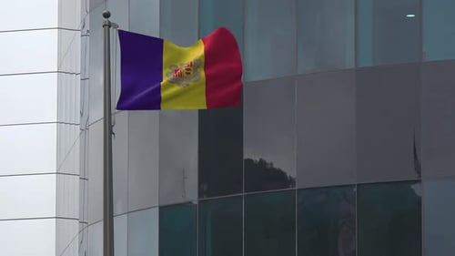 Andorra Flag Waving on Flagpole in Front of Modern Building