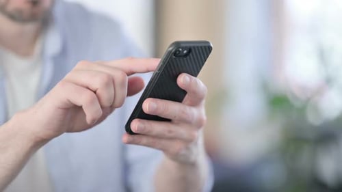 Close Up of Hands of Man in Glasses Using Smartphone