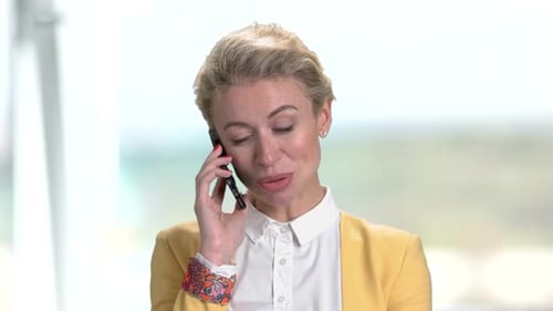 Mature Business Lady Having Phone Conversation on Phone