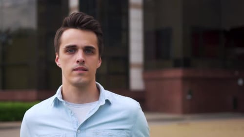 Handsome Young Man Smiling in City Setting