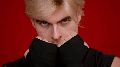 Intense Young Man With Fists Wrapped