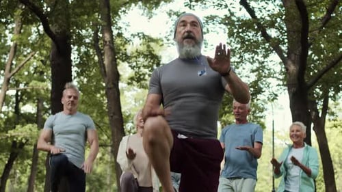 Instructor Leading Seniors in Outdoor Exercise Class