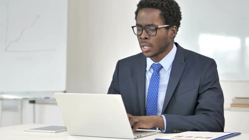 Business Man Coughing at Work While Using Laptop