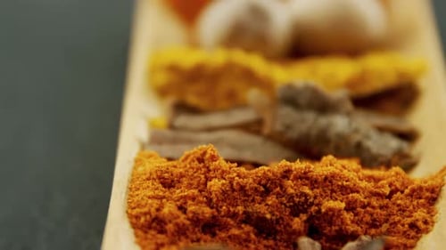 Assorted Spices Arranged on Wooden Tray
