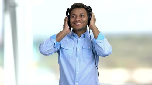 Man Listening to Music on Headphones and Dancing