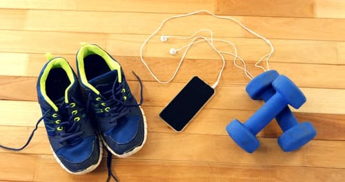 Fitness Accessories with Dumbbells, Phone and Shoes