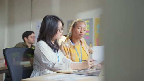 Asian staff creative senior designer coworkers consulting in office