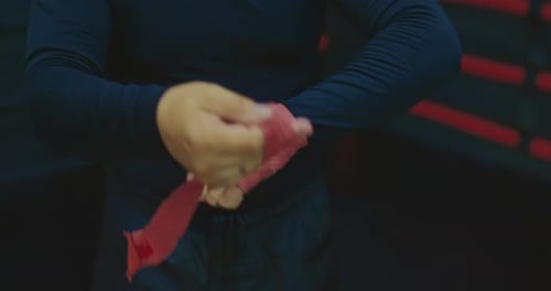 Kickboxer is Wrapping Hand Before Fight or Training Closeup View in Gym Prores