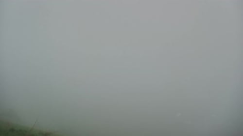 Misty Morning in a Mountain Village A Vanishing Fog Revealing a Settlement