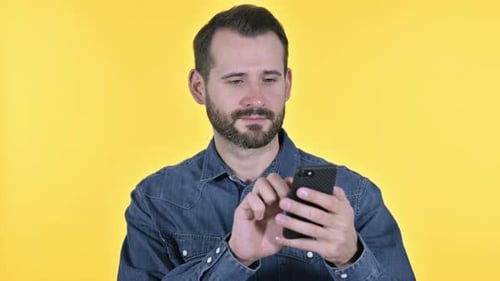 Man using Smartphone on Yellow Background