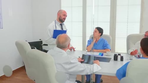 Medical Professionals Reviewing X-Ray in Bright Conference Room