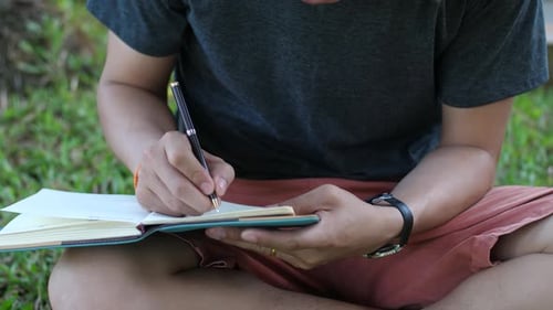Student Writing On Book