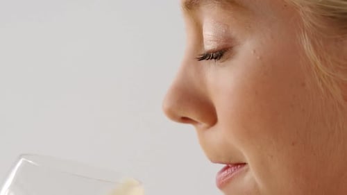 Blonde Woman Drinking Healthy Juice Close Up