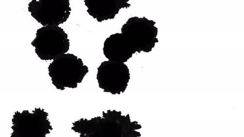 Black Ink Drops Expanding on White Background