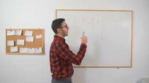 Man Explains Math Equation on White Board