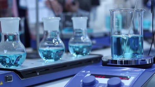 Blue Liquid Experiment in Laboratory Beakers and Flasks