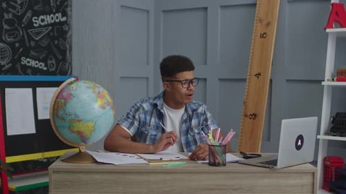 Young Adult Studies at Desk with Laptop