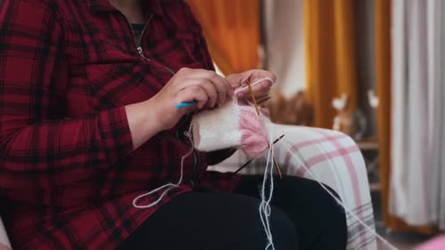 Woman Knitting with Needles Indoors