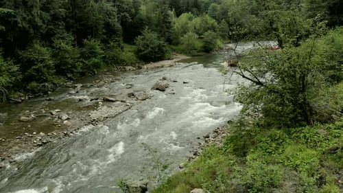 People Kayaking on Rapid Mountain River
