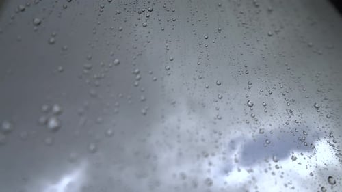 Rain Droplets on Glass in Close Up
