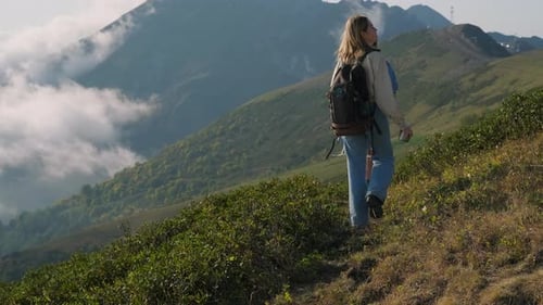 Hikers Walking Through Mountainous Landscape