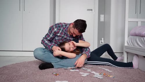 Playful Father Daughter Puzzle Time in Bedroom
