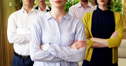Business people with arms crossed standing in a modern office 4k