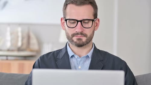 Close Up of Young Businessman Using Laptop at Home