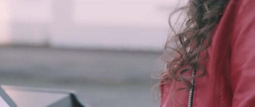 Woman Plays Piano Outside on Cloudy Day