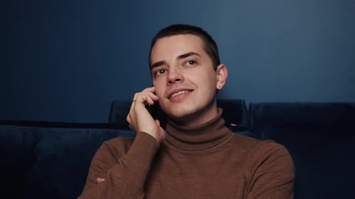 Close Up Smiling Man Talking Mobile Phone on Sofa at Home. Close Up of Cheerful Man Having Phone