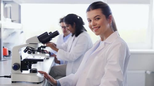 Smiling Scientist Gives Thumbs Up in Lab