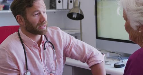 Doctor Talking to Elderly Patient in Medical Consultation