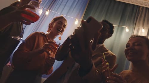 Friends Gather Around Phone at Party