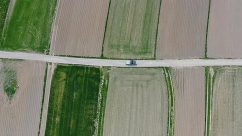 Car Drives Through Rural Farm Land From Above