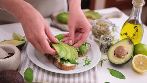 Woman Making Healthy Avocado Toast in Kitchen