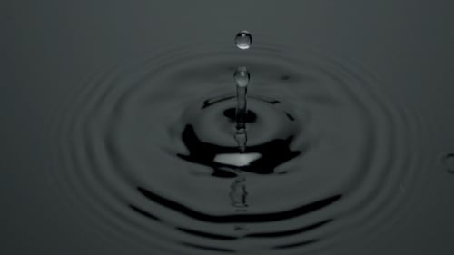 Water Droplet Creates Rippling Circular Background