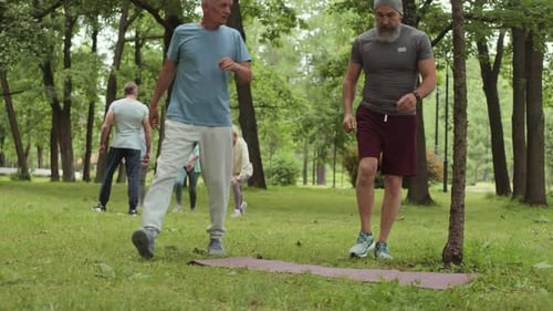 Two Aged Sportsmen Finishing Outdoor Run