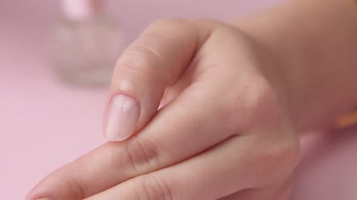 Close Up Woman Applying Liquid to Fingernail