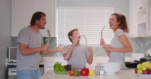 Family Having Fun Singing in the Kitchen