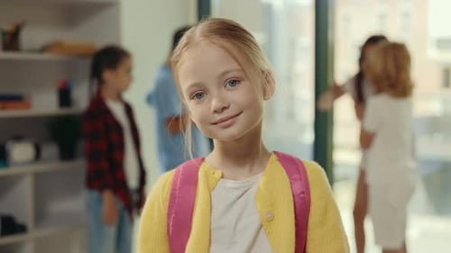 Portrait of the Girl Pupil on the School Break Standing in the Class Holding Backpack Looking at the