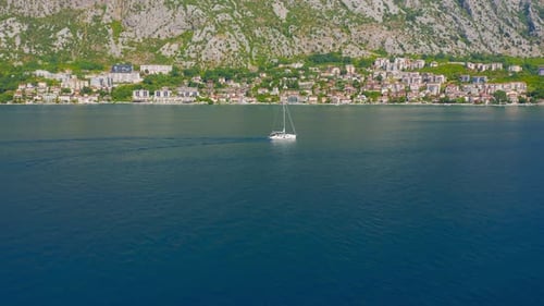 Sailboat at Open Sea with Beautiful Mountains and Blue Color Landscape